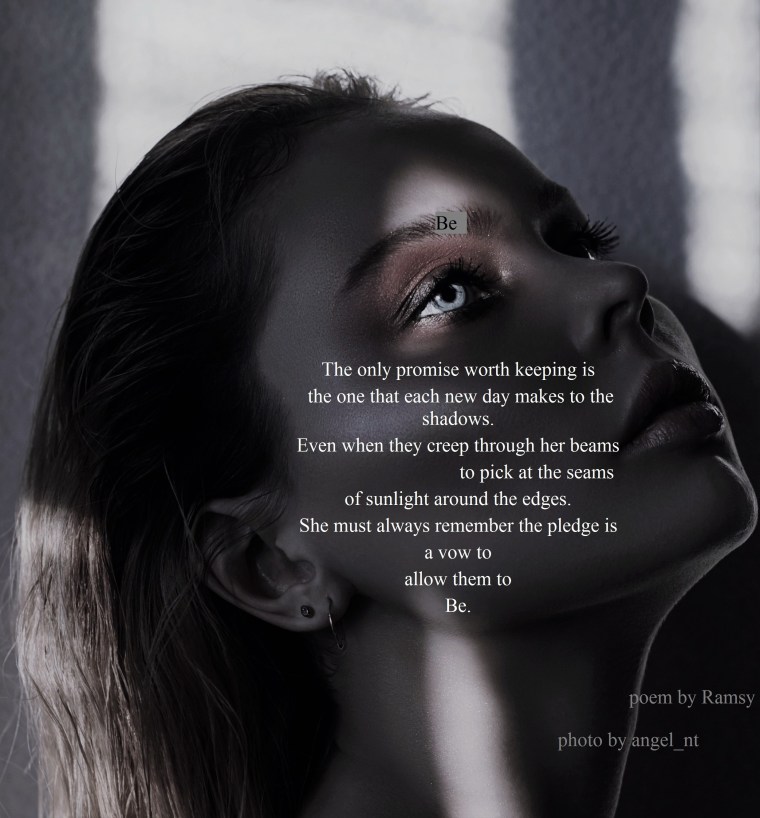 Art fashion contrast portrait of a woman near the window with a shadow on her face. Bright makeup, expressive emotions, mystical, mysterious way. Beautiful big eyes in the sun