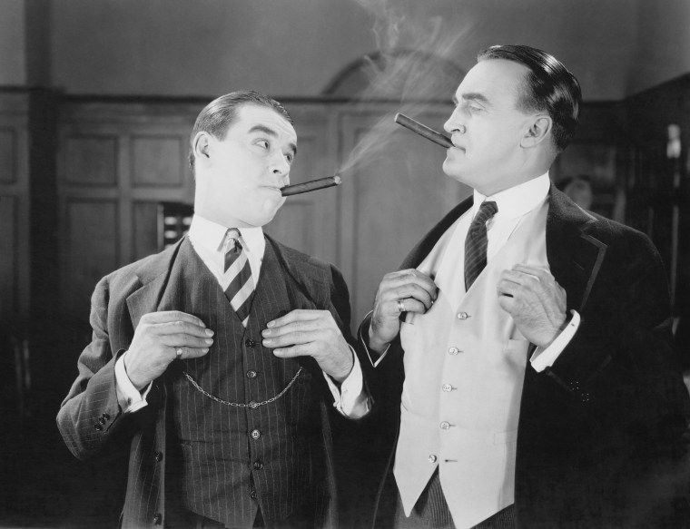 Two men smoking cigars