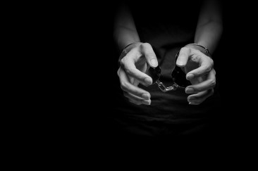 concept human trafficking,hand girl in shackle on isolate black background