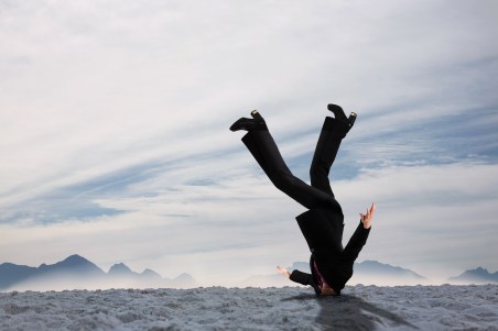 Composite image of businesswoman burying her head