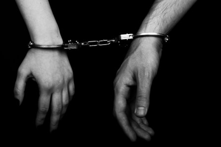 men and women cuffed hands together